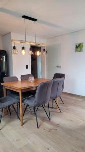 a dining room with a wooden table and chairs at Apartment Schwarzwaldmädel in Friedenweiler +7 photos