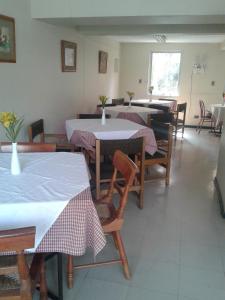a kitchen area with a table and chairs at Hostal Americano in Santiago