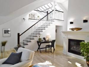 a living room with a table and a staircase at White Elephant Hotel in Nantucket