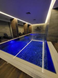 a swimming pool with blue water in a building at Notherland Premier Famagusta in Famagusta