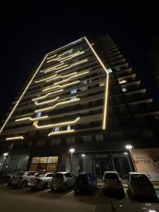 a building with cars parked in a parking lot at night at Notherland Premier Famagusta in Famagusta