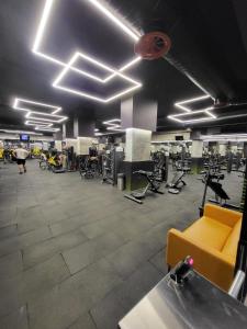 a gym with a yellow couch in a room at Notherland Premier Famagusta in Famagusta