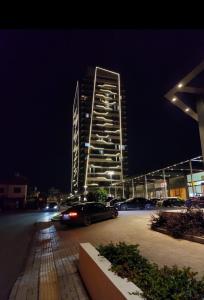 a car parked in a parking lot in front of a building at Notherland Premier Famagusta in Famagusta