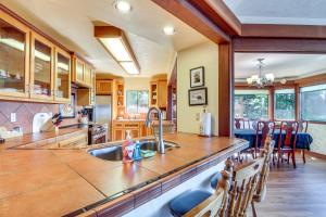 a kitchen with a sink and a counter top at Enchanting Coos Bay Sanctuary with Lush Views! in Coos Bay