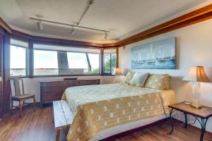 a bedroom with a bed and a large window at Enchanting Coos Bay Sanctuary with Lush Views! in Coos Bay