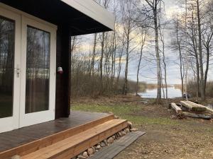 a porch of a house with a view of a lake at Saare-Toominga camping house in Väike-Rakke
