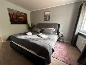 a bedroom with a large bed with two towels on it at Premium Apartments Schwetzingen, Heidelberg, Speyer in Schwetzingen