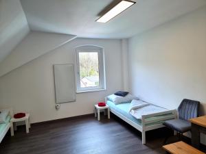 a small room with a bed and a window at Rentcenter79 in Sankt Peter-Freienstein