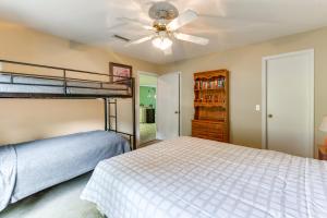 a bedroom with a bunk bed and a ceiling fan at Abbeville Cottage with Grill Steps to Lake Eufaula! in Abbeville