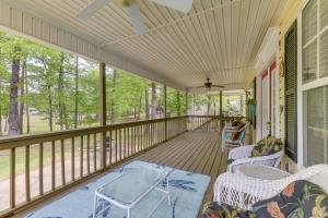a screened porch with chairs and a table at Abbeville Cottage with Grill Steps to Lake Eufaula! in Abbeville