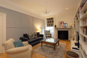a living room with a couch and a coffee table at Edenfield House, Springfield, Fife in Cupar