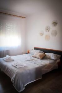 sypialnia z białym łóżkiem i ręcznikami w obiekcie Kuća za odmor Ante w mieście Ilok