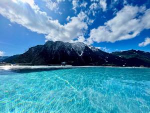 a large body of water with a mountain in the background at Familienresort Buchau in Maurach