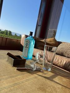 a bottle of alcohol sitting on a table next to a glass at Casa Felix in Las Heras