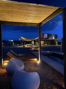 a pavilion with chairs and a building at night at Casa Felix in Las Heras