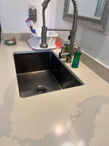 a kitchen counter with a sink and a sink at The Cottage at Ohia Kai. TVNCU#1354 in Kapaa