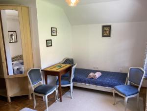 a room with a bed and a table and chairs at Homestead Zatrnik near Bled in Bled