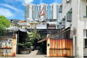 a city with tall buildings and a crane at Rucksack Inn at Tyrwhitt in Singapore