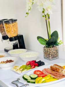 a table topped with plates of different types of food at SeaBreeze Relaxa BnB in Hibberdene