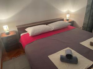a bedroom with a large bed and two night stands at Mirna in Senj