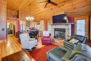 a living room with a couch and a fireplace at Luxurious Lakefront Paradise in Scottsboro with Dock in Scottsboro