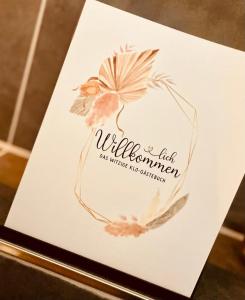 a card with a wreath of flowers on a table at Wellness-mit-Stil in Schwerte