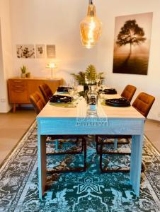 a blue table with chairs in a living room at Wellness-mit-Stil in Schwerte