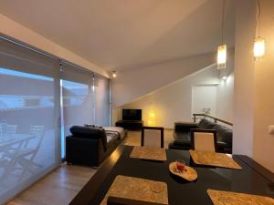 a living room with a couch and a table at Born To Stay In Milfontes in Vila Nova de Milfontes