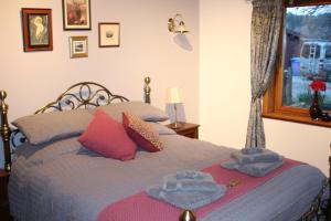 a bedroom with a bed with towels on it at Invercassley cottage in Lairg