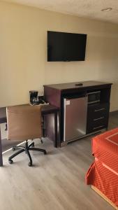 ein Büro mit einem Schreibtisch, einem TV und einem Stuhl in der Unterkunft Econo Lodge Las Vegas in Las Vegas