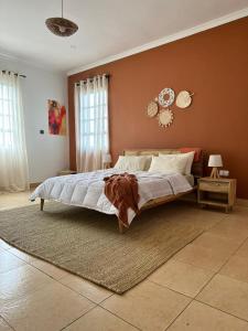 a bedroom with a large bed with a brown wall at Meru Villas in Arusha