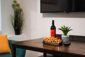 een fles wijn en een mand pretzels op een tafel bij EDMONTON - 4 bedrooms, Sleeps 8, 3 bathroom Contractor Base in Londen