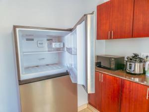 a refrigerator with its door open in a kitchen at Summer in Garuga in Entebbe