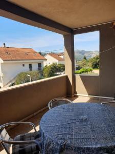 a table and chairs on a balcony with a view at Animari Apartments in Stari Grad