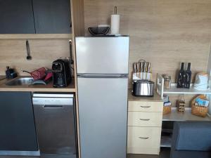 a kitchen with a white refrigerator and a sink at Mobile Home L&L in Drage