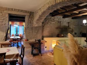 a living room with a couch and a table at Casale I Pioppi in Vitorchiano