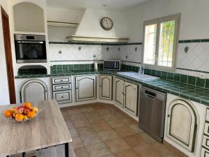 a kitchen with a bowl of fruit on a table at VILLA BIOT in Biot