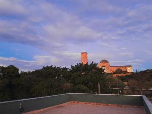 a view of a building in the distance with trees at Casa Maria Vitória in Aparecida