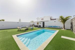podwórko z basenem i domem w obiekcie VILLA GARA w mieście Playa Blanca