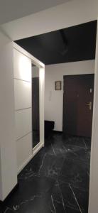 an empty room with a door and a black floor at W sercu Mazur in Kruklanki