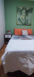 a bedroom with a bed with an angel picture on the wall at Alsancak Konak seaside 50 mt walk Double room in Konak
