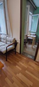 a living room with a couch and a mirror at Alsancak Konak seaside 50 mt walk Double room in Konak