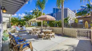 a patio with tables and chairs and an umbrella at B5021 South Mission Beach House in San Diego