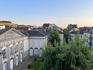 a large white building in the middle of a city at Appartement de Paul in Aurillac