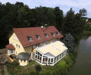 an aerial view of a large house on a river at AL GONDOLIERE in Oppach