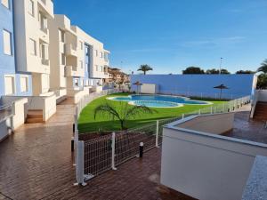 a balcony of a building with a swimming pool at Mar Menor Paradise by Los Pinos Holidays in San Pedro del Pinatar
