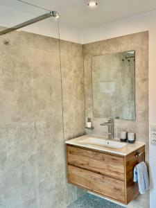 a bathroom with a sink and a mirror at Apartment Rose in Ahausen