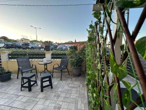 a patio with four chairs and a table and a fence at Studio One in Kanálion