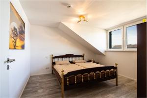 a bedroom with a bed and a staircase at Helle Wohnung mit Stellplatz in Hermeskeil