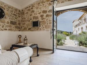 a bedroom with an open door to a patio at BRAMASOLE Charming House in Comiso